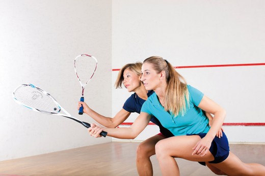 Squash sport - women playing on gym court